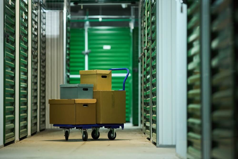 Stack,Of,Cardboard,Boxes,On,Blue,Hand,Truck,Standing,In
