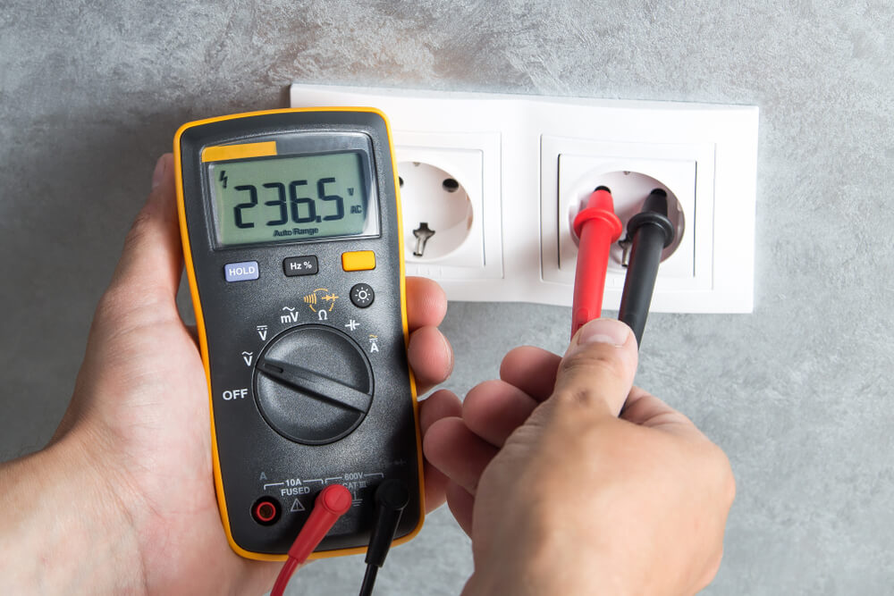 Electrician,Checking,Voltage,In,Socket,With,Tester.,Professional,Multimeter,In